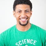 Contact. Portrait of a smiling young man wearing a green T-shirt with science text.